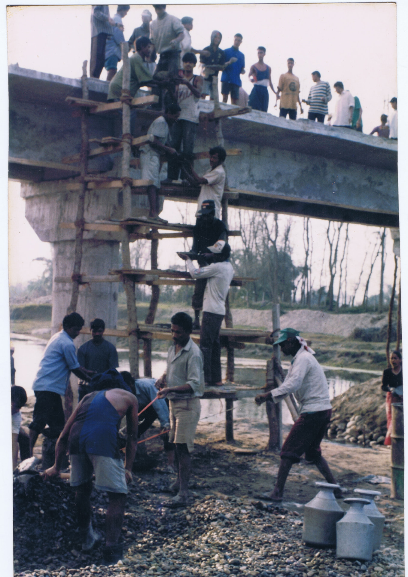 Community members constructing a bridge together